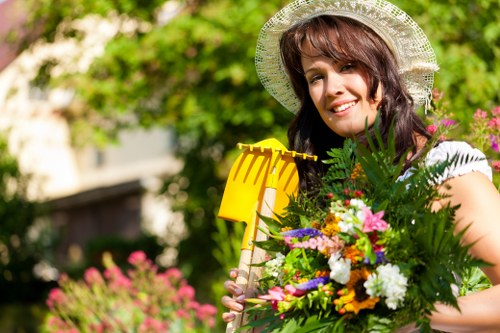 Seasonal garden maintenance activities in a Swiss Cottage landscape